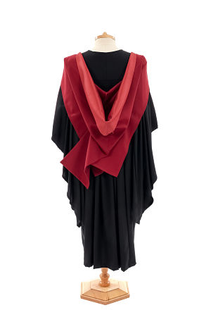 The back of a bachelors degree gown, sitting on a clothes stand.